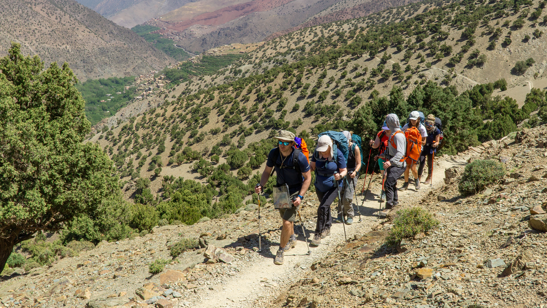 Group of walkers taking part in expedition, rural setting.